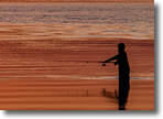 Fisherman enjoys a beautiful sunset and the NYC skyline from Green Island, Wantagh, photo by Fred Greco